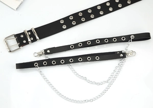 Close-up of black punk leather belt with double grommets and metallic silver chains