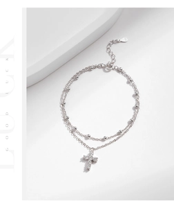 Detail view of double-layer S925 sterling silver bracelet with cross and bead charms