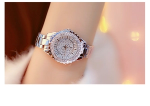 Detailed close-up of a silver ladies' watch with sparkling rhinestones on model's wrist