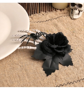 Close-up of gothic Halloween hair clip with black rose, skeleton hand and spider detail