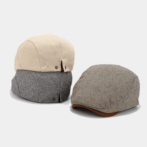 Classic men's herringbone newsboy caps in beige, dark grey, and brown retro style
