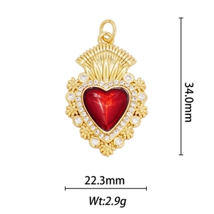 Detail view of heart wing pendant with red gemstone and 18k gold plating details