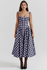 Detail view of purple and green plaid strap dress with fitted waist and flared hem