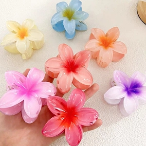 Macro detail of colorful translucent Plumeria hair claws in various vibrant gradient shades