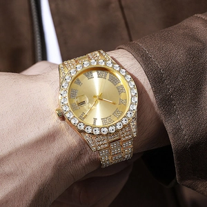 Close-up of luxury gold hip hop watch for men with rhinestones on the bezel and band