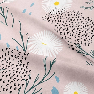 Close-up of bohemian wall tapestry showing floral daisy pattern and soft fabric texture