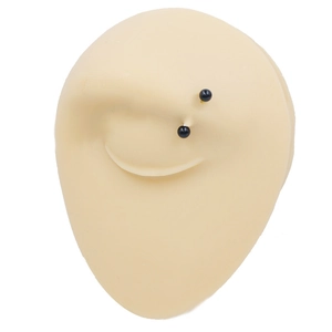 Minimalist black eyebrow piercing jewelry on a silicone realistic lip piercing practice model