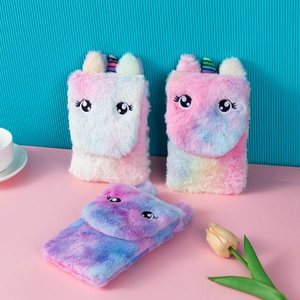 Close-up of plush unicorn phone bags with tie-dye finish and embroidery details