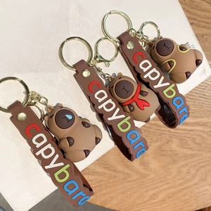 Cute brown Capybara PVC keychains with different outfits and colorful strap loops