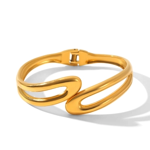 Detailed macro view of the double-loop gold stainless steel bracelet with hinge mechanism