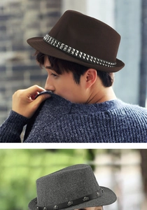 Detail view of wool felt fedora hats with metal studs and skull belt buckle decorations