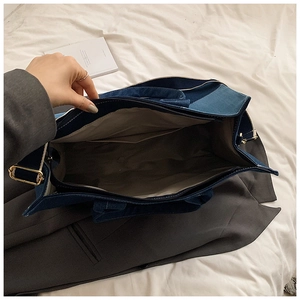 Internal view showing spacious main compartment and inner pocket of denim tote bag