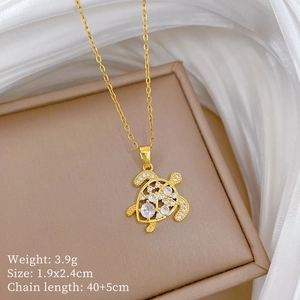Detail shot of golden sea turtle necklace with crystal pave stones and size specifications