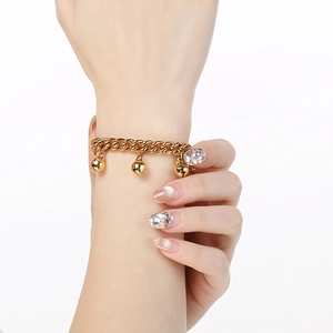 Minimalist 18K gold plated stainless steel chain bracelet with bell pendants on hand