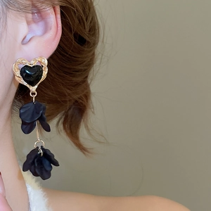 Close-up of black heart floral tassel earrings on model in elegant French court style