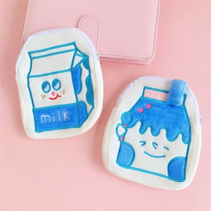Detail of soft plush milk carton coin purses with cute embroidery and secure zipper closure