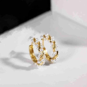 Elegant gold twist hoop earrings with white pearls, minimalist luxury jewelry for women