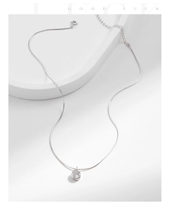 Detail of s925 silver snake chain necklace with sparkling zircon pendant and lobster clasp