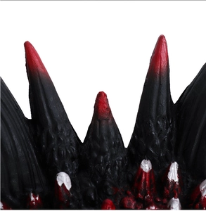 Detailed macro view of dragon mask featuring black and red scales with silver spikes