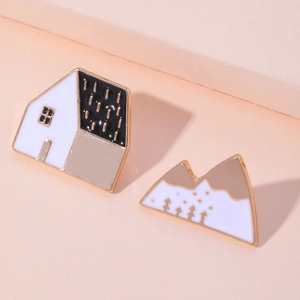 French romantic house and mountain enamel pin set with gold trim on pink background