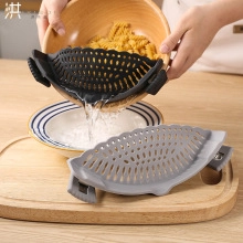 Silicone clip-on strainer draining pasta from a bowl, high-quality heat-resistant kitchen tool