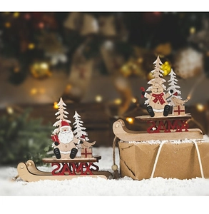 Detail of wooden Christmas sleigh ornaments with Santa and reindeer on snow