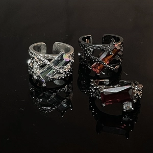 Detailed view of Gothic open rings with thorny bands and vibrant rectangular gemstones