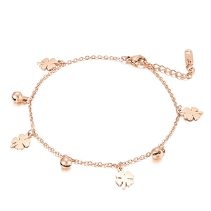 Elegant rose gold anklet featuring lucky clover and bell pendants on a white background