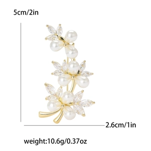 Elegant vine branch brooch with pearls and cubic zirconia on white background