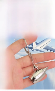 Macro shot of silver zinc alloy aircraft engine turbine keychain with custom laser engraving