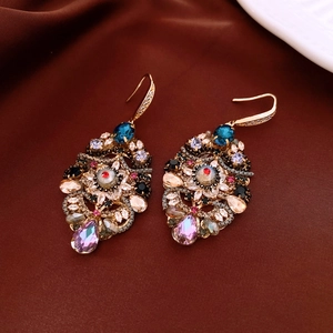 Detailed macro view of vintage baroque drop earrings with colorful zircon crystals
