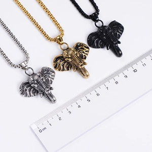 Detailed size view of elephant pendants in silver, gold, and black with a ruler guide