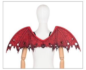 Detailed view of red dragon wings with black scales and ragged edges for cosplay costumes