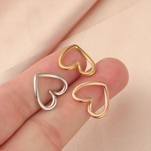 Minimalist stainless steel heart rings in silver, gold, and rose gold on fingers