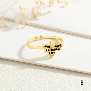 Macro shot of bee ring with black cubic zirconia on gold-plated adjustable band