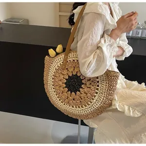 Detail of sunflower woven straw beach tote bag with leather strap and reinforced stitching