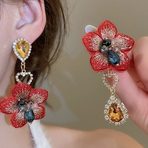 Dettaglio orecchini a fiore ricamati rossi con cristalli a goccia e strass a forma di cuore