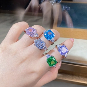 Detailed view of five colorful S925 silver rings with radiant cut three-stone crystals