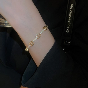 Close-up of gold-plated chain bracelet with micro-pave cubic zirconia on the wrist