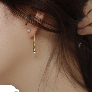 Elegant 925 silver pearl drop earrings with golden water-drop pendant on model