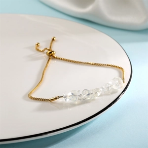 Detail of adjustable gold stainless steel box chain bracelet with natural white crystals