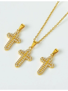Detailed view of gold-tone cross pendants with pavé-set cubic zirconia stones