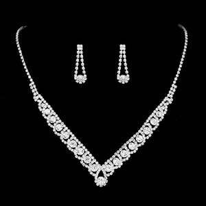 Detailed view of silver bridal jewelry set with sparkling rhinestones on black background