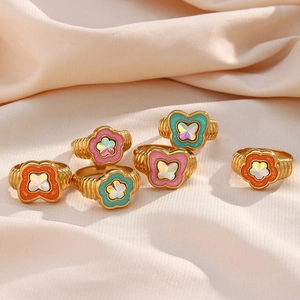 Set of 6 vintage gold rings with colorful floral patterns and crystals on white silk