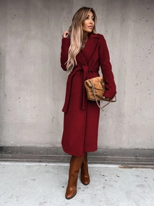Detail of burgundy wool coat with a classic lapel and matching waist tie belt