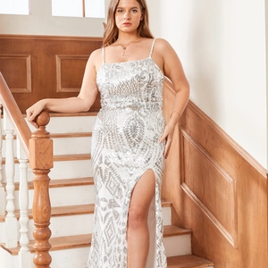 Close-up of sparkling silver sequin maxi dress with a thigh-high slit on a model