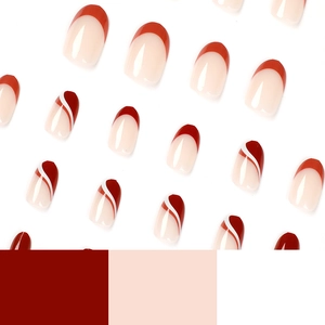 Short round press-on nails with red French tips and elegant wavy line designs