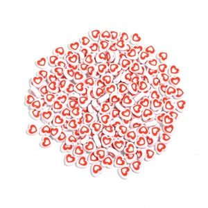 Macro shot of 8mm acrylic white heart beads with red patterns for DIY jewelry making