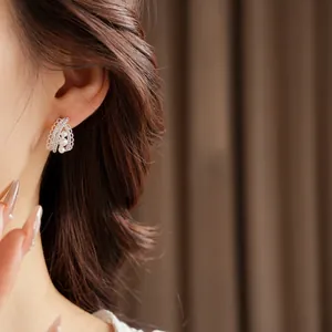 Silver needle pearlescent drop earrings with hollow metal design and three white pearls