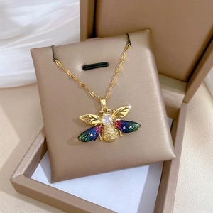 Elegant gold bee necklace with colorful gradient wings and pavé zircon settings